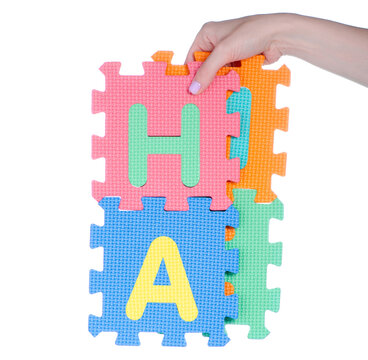 mat puzzles alphabet in hand on white background isolation
