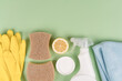 Green household concept. Bio organic detergent products, homemade cleaning detergents. Natural household cleaners  over green background with copy space. Homemade improvised cleaning products
