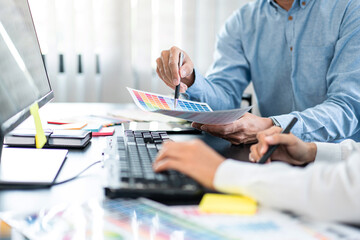 Poster - Team graphic designer working on document of color chart to brainstorming about new project and using laptop