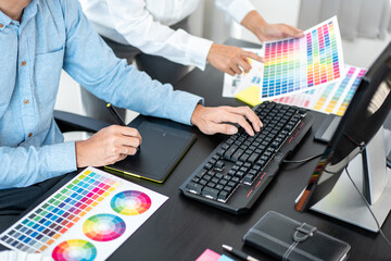 Poster - Team graphic designer working on document of color chart to brainstorming about new project and using laptop