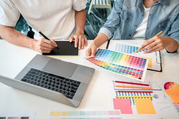 Poster - Team of creative graphic designer working on color swatch samples chart for selection coloring in inspiration to create new collection at workplace
