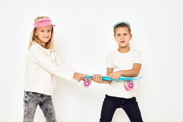 Portrait of two young smiling kids casual street style light background