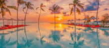 Luxury Sunset Over Infinity Pool Beautiful Beachfront Resort Tropical Landscape. Panoramic Beach, Summer Holiday Vacation Background. Amazing Island Sunset Beach View, Palms Swimming Pool Reflection