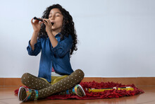 Latin American Girl Plays The Piccolo Recorder
