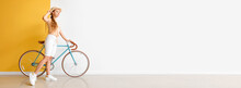 Pretty Young Woman With Bicycle Near Color Wall. Banner For Design