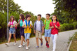 © Studio Romantic - Happy friends walking home from school. Little school children walking and talking. Group of students in casual clothes walking along park path. Cheerful kids going to first class this academic year