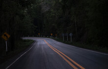 Road On The Dark View On The Mountain Road Among Green Forest Trees - Curve Asphalt Road Lonely Scary At Night