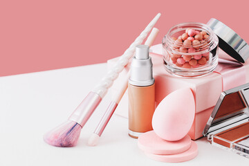 Tender pink feminine makeup tools and accessories. brushes blush foundation sponges pearls on on candy pink. Birthday beauty cosmetics blogger advert border concept.