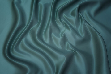 Wall Mural - Texture, background, pattern. Texture of green silk fabric. Beautiful emerald green soft silk fabric.