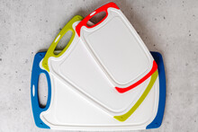 Set Of Plastic Cutting Boards In Different Colors And Sizes Close-up From Above With Copy Space