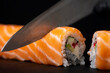 Cook hands making sushi roll closeup photo
