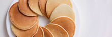 Plate With Many Round Pancakes Standing On White Background Top View
