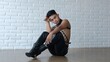 © Sia - A handsome gay man sits on the floor in leather clothes and heels. LGBT community with freedom for homosexuals. An Asian model with feminine features but in a masculine body.