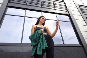 Portrait of a businesswoman with a mobile phone on the street