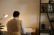 © DragonImages - Architect working at desk in dark office with pencil behind his ear