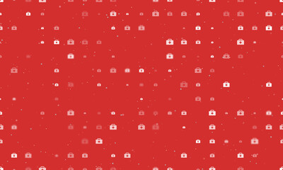 Seamless background pattern of evenly spaced white first aid symbols of different sizes and opacity. Vector illustration on red background with stars