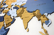 India and Sri Lanka on the map. Wooden color multilayer world map on a white wall.