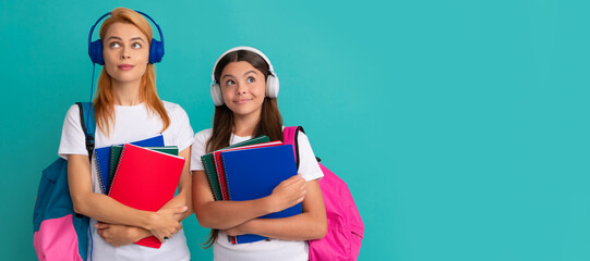 Poster - Mother and daughter child banner, copy space, isolated background. thoughtful private teacher and kid in earphones holding textbook and school bag, estudy.