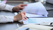 © Prathankarnpap - Cropped shot professional businesswoman holding pen and checking financial graph at her office desk