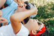 © Natallia - Close up little hands of boy holding eat yummy ice cream at camping or home garden backyard at vacation. Teen child with dirty nose face licking icecream refreshing in heat. Summer food.
