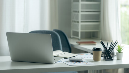 Laptop blank screen on wood table with business office background, mockup, template for your text