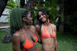 © ADDICTIVE STOCK - Cheerful black women in swimsuits standing near grove