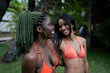 © ADDICTIVE STOCK - Cheerful black women in swimsuits standing near grove