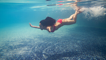 At the pool, Asian women are diving. She had on a bikini.