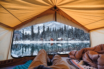 Wall Mural - Traveler man relaxing in large tent with cottage in the forest at Lake O'hara