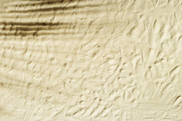 Wall Mural - Natural fine sand stone texture with palm leaf shadow as background. Top view sand texture, sandy beach backdrop. Sunlight and shadows, summer sunny day, natural textured surface.