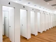 White Theme Minimalism Changing Room. White Wall And Wooden Floor