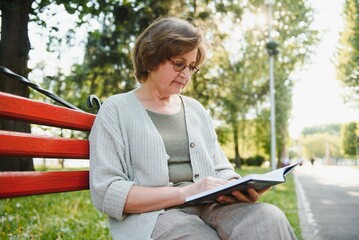 Sticker - Retired woman reading a book on the bench