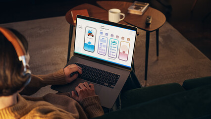Poster - Young Handsome Men Working On Laptop Computer, Sitting on The Sofa in Stylish Loft Apartment. Creative Designer is Developing UX/UI for New Project, Preparing Presentation For the Clients.