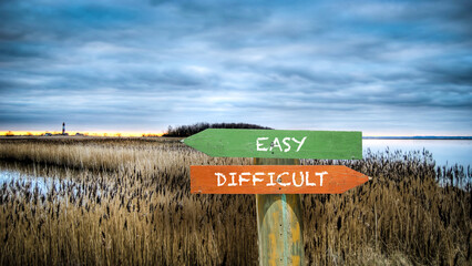 Wall Mural - Street Sign to Easy versus Difficult