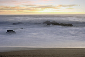 Wall Mural - Rocky beach at sunset or dusk