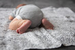© Cavan Images - newborn lies on his stomach on a large bed