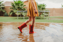 Girl Walking In Rainboot In Eater Puddle
