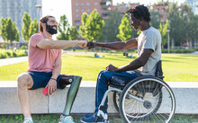 Two Disabled Friends Give Fist Bump As A Sign Of Friendship  And Determination