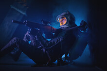 Spaceman Or Star Trooper In The Helmet And With Rifle In The Blue Smoke. Science Fiction Concept.