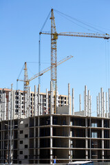 Construction site background. Cranes and new high-rise buildings. Reference information about the industry.