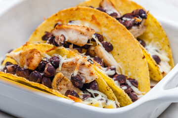 Wall Mural - tacos filled with grilled chicken meat, red beans and grated cheese