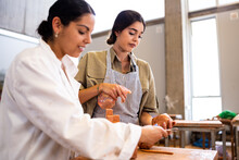 Hispanic Women Working With Clay Together