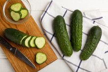 Sliced Cucumber.Fresh Cucumbers On A White Texture Background. Sliced Cucumber Slices For Salad.Vegetarian Organic Vegetables.Healthy Food.Copy Space.Place For Text