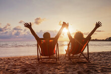 Beach Holidays, Happy Retired Couple Enjoying Sunset Near The Sea, Holding Hands