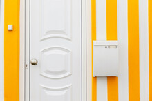 Beautiful Creative House With Yellow And White Stripes With Doors And Mailbox. Delivery And Letters, Concept. Letter Delivery To The Door.