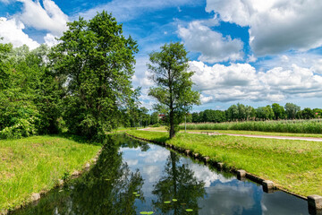 Wall Mural - Rural landscape, river among green meadows