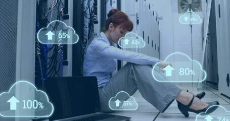 Wall Mural - Animation of cloud icons with growing numbers over caucasian woman in server room