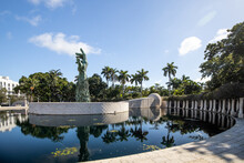 MIAMI BEACH, FL, USA - OCTOBER 14, 2019: The Holocaust Memorial In Miami Beach Features A Reflection Pool With A Hand Reaching Up And Bodies Climbing,  A Memorial Wall, And Memorial Bridge.