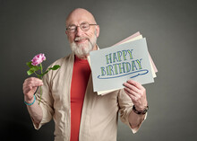 Happy Birthday - Smiling Senior Man With Pink Rose And Greeting Card