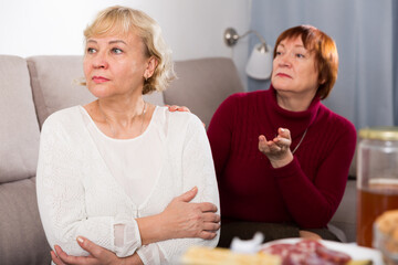 Wall Mural - Quarrel between two senior women in home interior